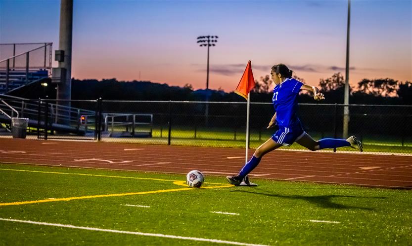 A soccer player prepares to kick the ball